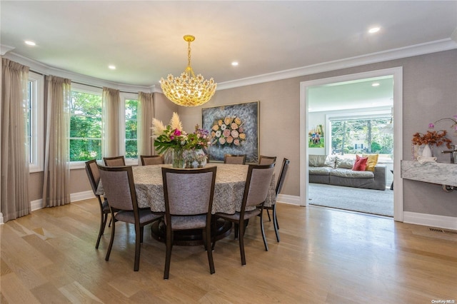 dining room with plenty of natural light, an inviting chandelier, and light hardwood / wood-style flooring