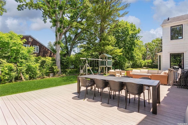 wooden terrace with an outdoor living space and a playground