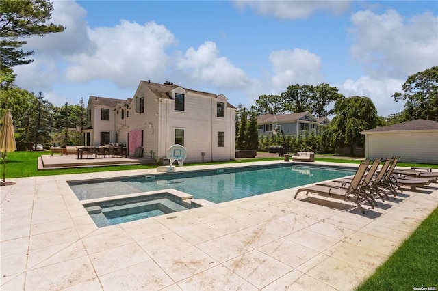 view of swimming pool with a patio area and an in ground hot tub