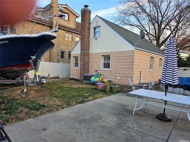 rear view of house featuring central AC and a patio area