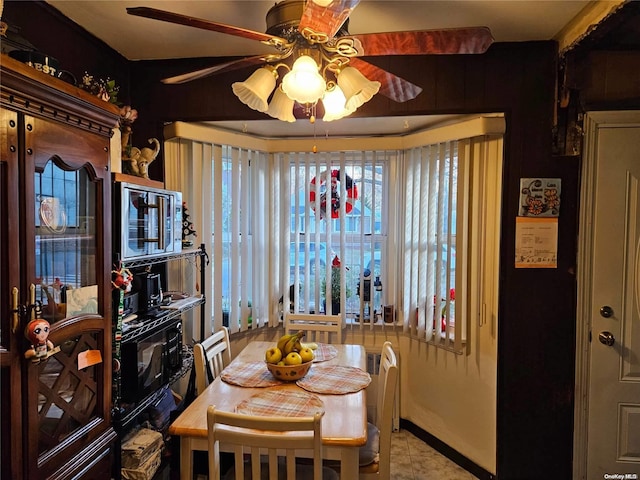 dining space with light tile patterned floors, a wealth of natural light, and ceiling fan