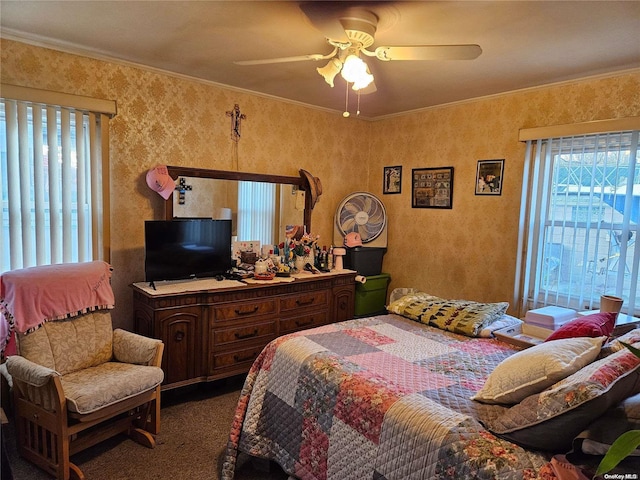 bedroom featuring ceiling fan, ornamental molding, and carpet floors