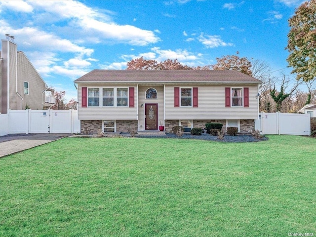 split foyer home with a front lawn