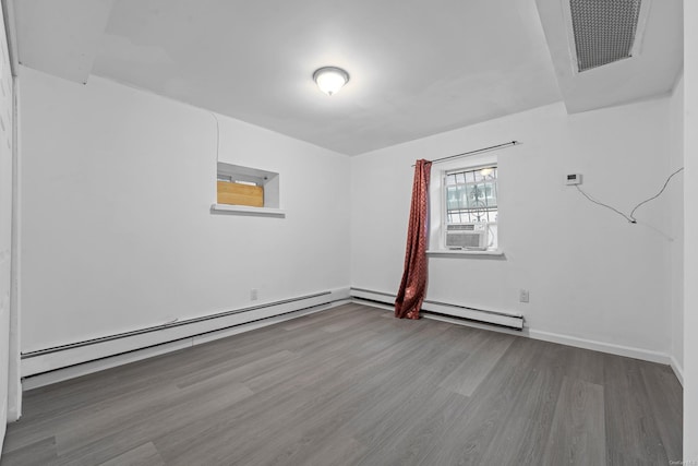 unfurnished room featuring cooling unit, a baseboard radiator, and hardwood / wood-style floors