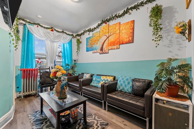 living room featuring wood-type flooring and radiator heating unit