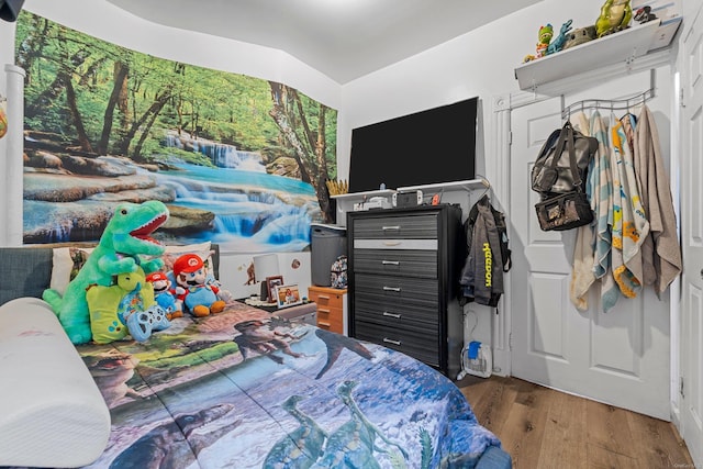 bedroom with vaulted ceiling and dark hardwood / wood-style floors