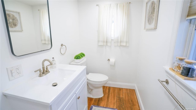 bathroom featuring hardwood / wood-style floors, vanity, and toilet