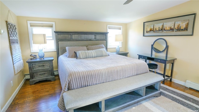 bedroom with ceiling fan, dark hardwood / wood-style flooring, baseboard heating, and vaulted ceiling