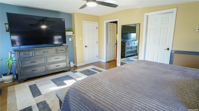 bedroom featuring hardwood / wood-style floors, ceiling fan, and lofted ceiling