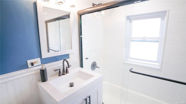 bathroom featuring vanity and combined bath / shower with glass door