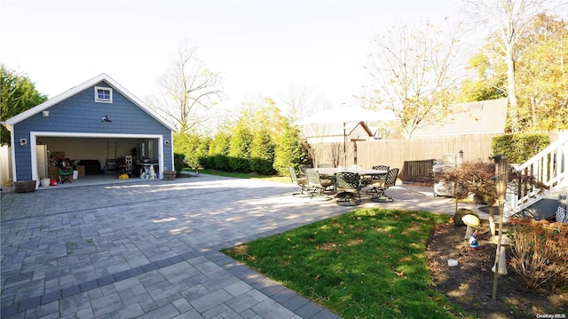 view of patio with an outdoor structure and a garage