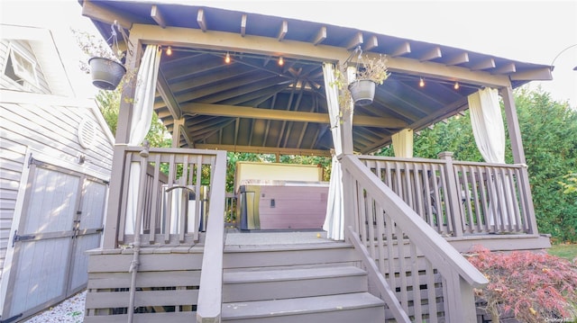 deck with a gazebo and a hot tub