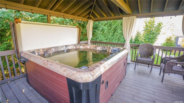 deck with a gazebo and a hot tub