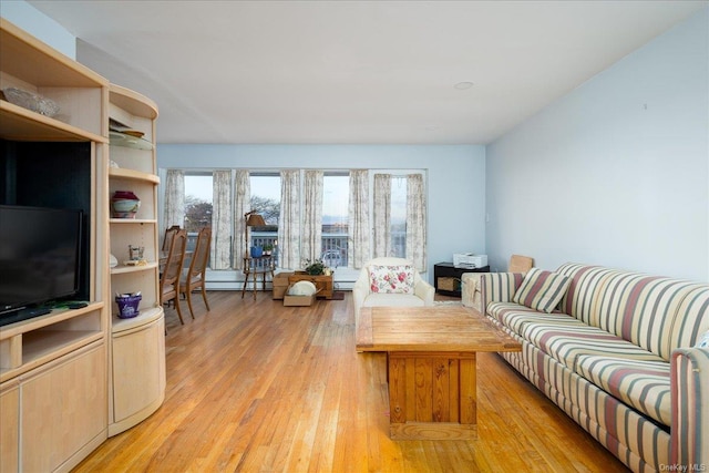 living room with light hardwood / wood-style flooring and baseboard heating