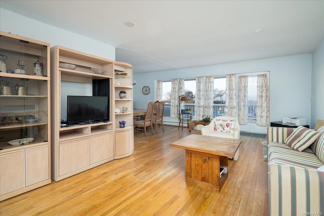 living room featuring light hardwood / wood-style floors and a baseboard radiator