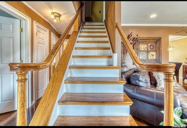 staircase featuring ornamental molding