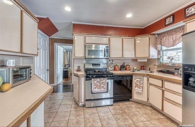 kitchen featuring crown molding, sink, light tile patterned floors, and appliances with stainless steel finishes