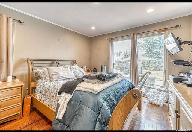 bedroom featuring hardwood / wood-style flooring and crown molding