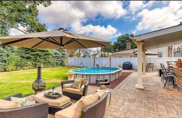 view of patio / terrace featuring a fire pit and a fenced in pool