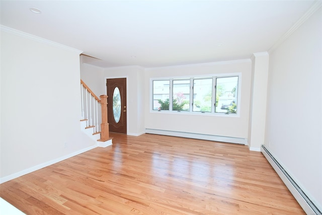 foyer entrance featuring baseboard heating, light wood-style flooring, stairway, crown molding, and baseboards