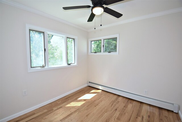 unfurnished room featuring a baseboard radiator, light wood-style flooring, baseboards, ornamental molding, and ceiling fan
