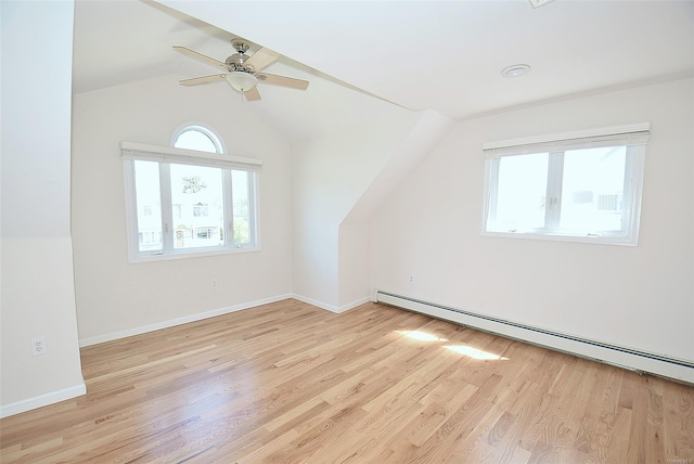 bonus room featuring baseboard heating, ceiling fan, wood finished floors, vaulted ceiling, and baseboards