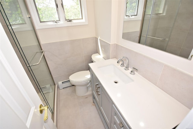 full bathroom featuring plenty of natural light, baseboard heating, a stall shower, vanity, and tile walls
