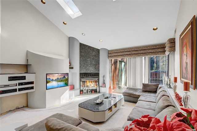 living room with a tile fireplace, a wealth of natural light, and high vaulted ceiling