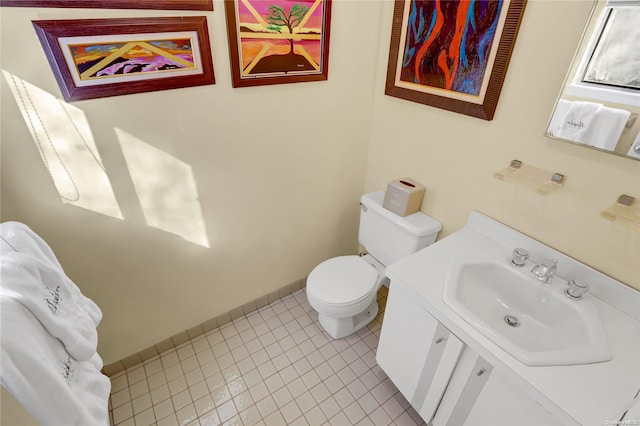 bathroom with tile patterned flooring, vanity, and toilet