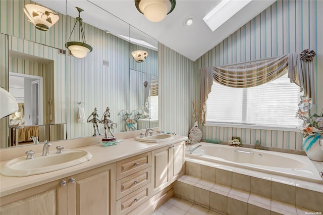 bathroom with a wealth of natural light, tile patterned flooring, vanity, and lofted ceiling with skylight