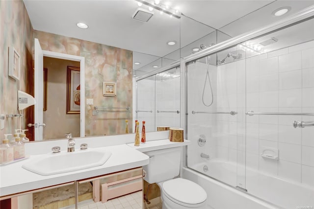 full bathroom with shower / bath combination with glass door, sink, and toilet