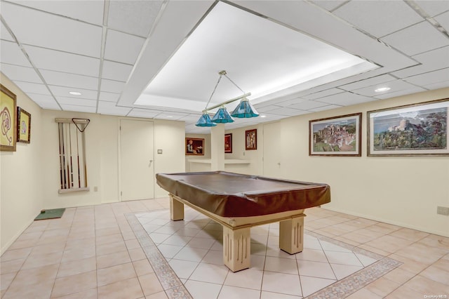 game room featuring a paneled ceiling, light tile patterned floors, and pool table