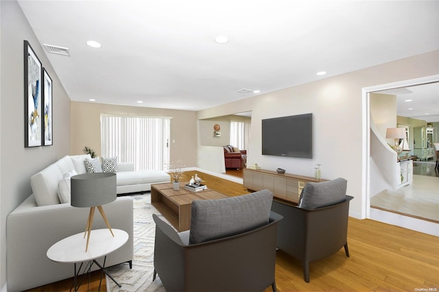 living area with light wood finished floors and recessed lighting
