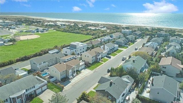 drone / aerial view with a water view and a beach view