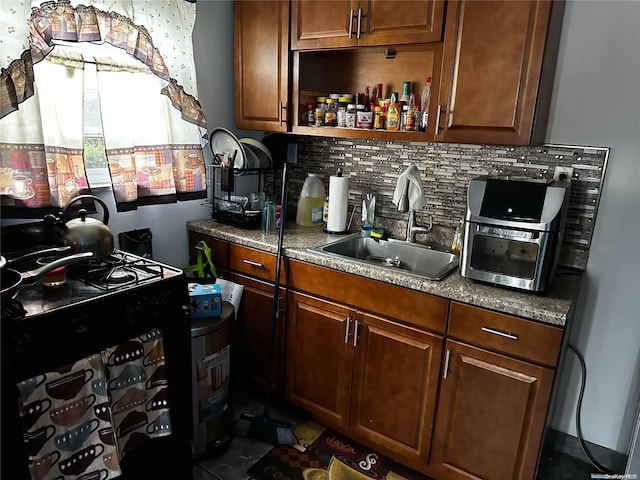 bar with decorative backsplash, black / electric stove, and sink