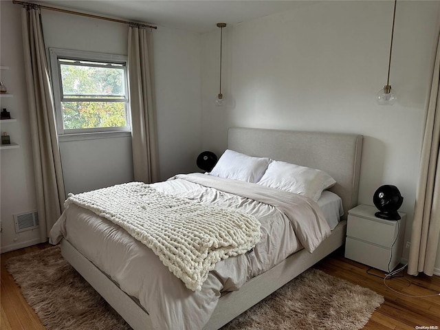 bedroom with hardwood / wood-style floors