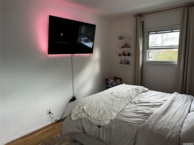 bedroom with hardwood / wood-style floors