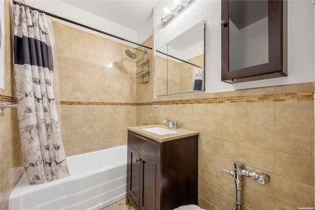 bathroom featuring vanity, shower / tub combo, and tile walls