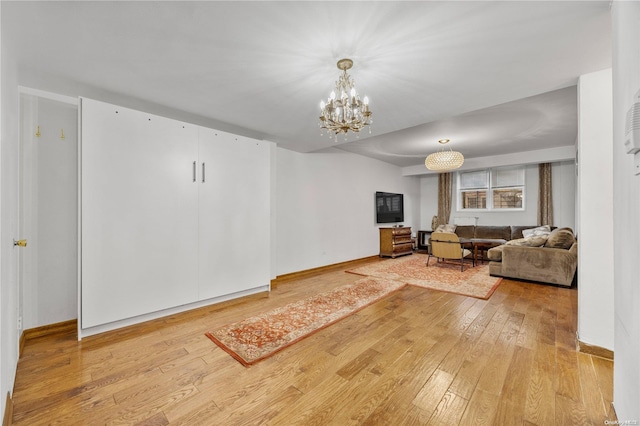 living room featuring hardwood / wood-style flooring and a notable chandelier