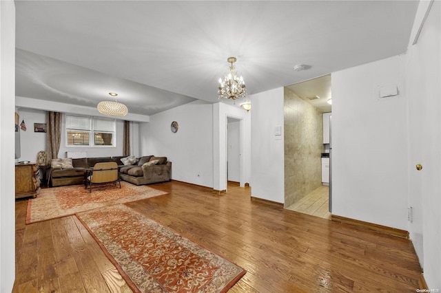 living room with wood-type flooring and an inviting chandelier