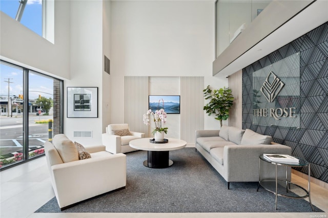 tiled living room featuring a high ceiling