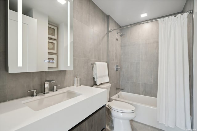 full bathroom with decorative backsplash, shower / bath combo, tile walls, tile patterned flooring, and toilet