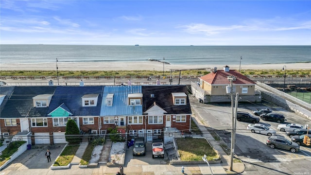 birds eye view of property with a water view and a view of the beach