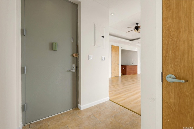 corridor featuring electric panel and light hardwood / wood-style flooring