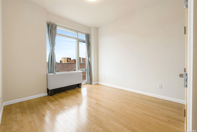 empty room with light hardwood / wood-style flooring