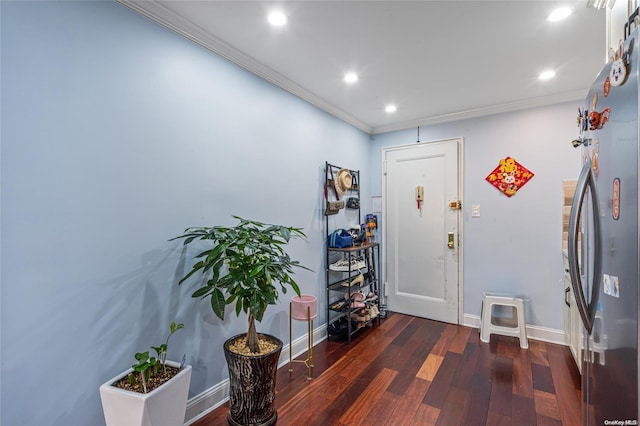 foyer entrance featuring dark hardwood / wood-style flooring and ornamental molding