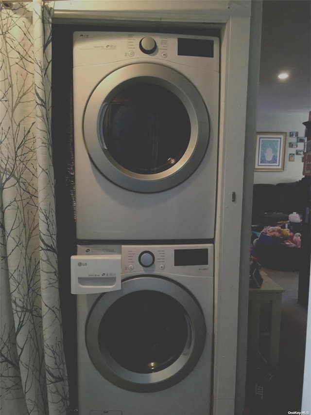 laundry area with stacked washer / drying machine