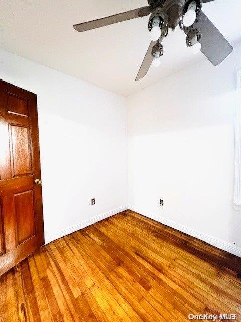 empty room with wood-type flooring and ceiling fan