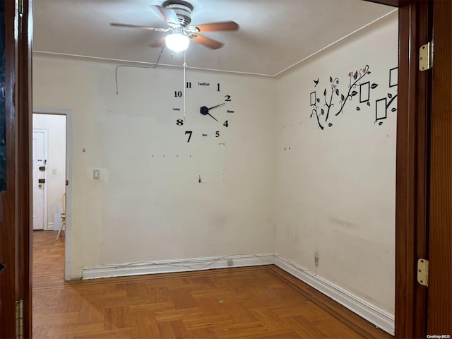 spare room featuring ceiling fan and parquet floors