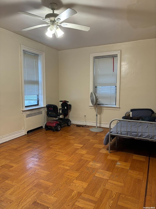 bedroom featuring ceiling fan and radiator